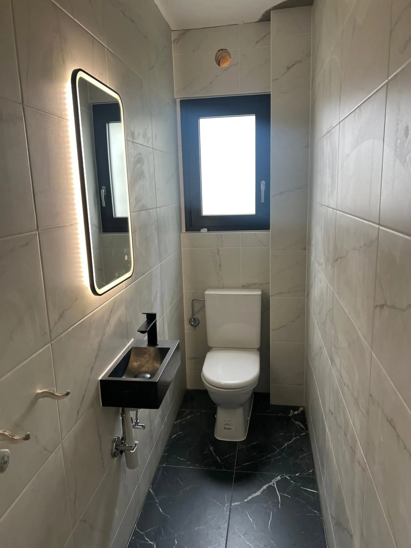 WC séparé marbre blanc avec lavabo noir suspendu
